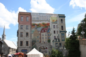 Quebec City, Quebec, Canada (2005): For optical illusions, the best example in my collection is this building in Quebec. One wall is covered with images suggesting a collection of buildings of varying heights, even with trees in the background. I zoomed in for more details seen in the second photo, below.
