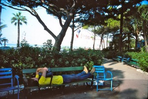 Understandably an exhausted traveler after a night camping out in front of a train station, Scott catches a short nap on a park bench in Nice.