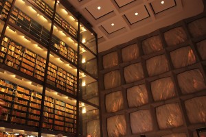 Interior of the Beinecke Library, with some of the protected books — sheltered in an interior reduced-oxygen space — visible here. Marble walls are visible at right.