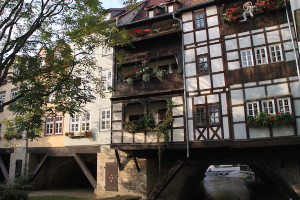 Kramerbrucke, or Merchants Bridge. Buildings, mostly houses, occupy both sides of the bridge. The bridge for road traffic is parallel to this one.