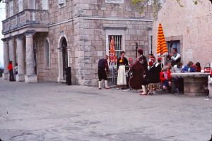 Entertainers prepare to perform for visiting Americans in Cilipi’s central square in 1976.