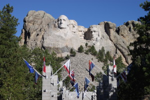 Our stone-faced presidents in stately formation on Mount Rushmore, with flags of all the U.S. states and territories in the foreground.