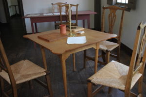 Table and chairs in the Pitt Tavern, set up for board games typical of the 1770s. Those games could include checkers, games with marbles and something called the game of fox and geese.