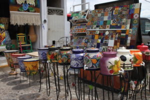 Vibrantly colored ceramics offered for sale, including large water dispensers used in the home. To be sure, my ceramic souvenirs were smaller!