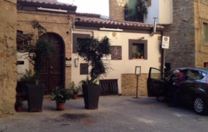 Partial view of our compact car at right. It stands in front of the apartment where my friends and I stayed in Piazza Armerina. Photo by Judy Lemberger.