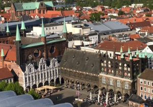 Lubeck’s city hall, seen from St. Peter’s Church in the city’s medieval center. The three attached buildingsseen facing a plaza comprise the city hall. The city hall and St. Peter’s had to be mostly or entirely rebuilt after World War II.