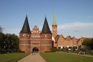 St. Peter’s steeple, which provides the vantage point for bird’s-eye views of Lubeck’s city center. In the foreground are the medieval Holsten Gate and several of the warehouses dating from Hanseatic League days. The gate and warehouses survived World War II bombing.