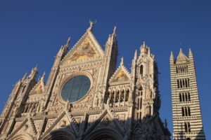 Facade of the Siena Cathedral, seen in late-day sunlight.