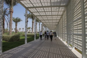We departed the Louvre Abu Dhabi via this walkway. It’s white like the museum’s buildings and it protects from sun and heat the way the dome does, with shade broken by shafts of light.