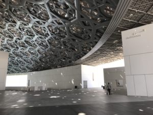Above and below, outdoor spaces at the Louvre Abu Dhabi under the aluminum and steel canopy that protects visitors from excessive sun and heat. 