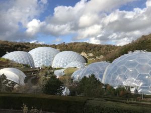The Eden Project’s two biospheres. The set of domes at left covers the indoor rain forest, while the set at right encompasses Mediterranean types of environments. The white structure at lower left is site of the project’s stage.