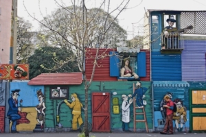 Buenos Aires, Argentina (2005): Street artists assembled a ragtag collection of materials to create the appearance of activity along the rim of an apparently abandoned, or at least unused, lot. The result features amusing characters, some painted and a few as sculpted figures.