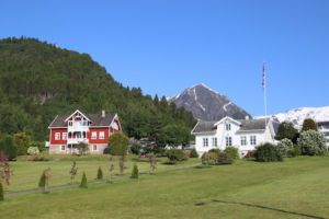 Above, houses on the main drag in Balestrand. Below, the town of Balestrand, stretched out along the Sognefjord shoreline.