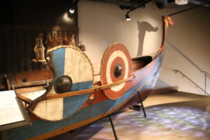 On exhibit at the Viking Museum, the recreated version of a Viking boat, adorned with shields on the sides.