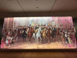 A huge reproduction of a 19th century lithograph called “Evacuation Day,” illustrating General Washington’s triumphant return to New York on Nov. 25, 1783, one of several popular Revolutionary Era subjects for artists.