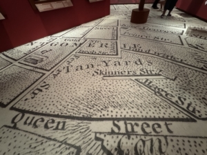 Parts of an old map of New York’s Manhattan seen on the floor of “The Occupied City” exhibition at the Museum of New York City. 