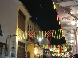 Phuket Old Town side street lighted for after-dark visitors.