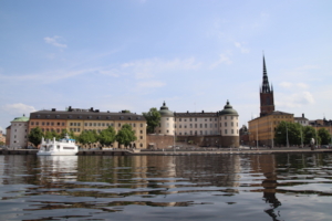 Above, view of Riddarholmen, a tiny island next to Gamla Stan (Old Town), seen from the boat tour. Below, further images caught during the boat tour, colorful houses near the water line, pleasure boats from one end of the horizon to the other and a waterside warehouse, irresistible with its vivid red paint job. 