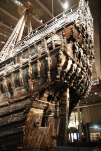 Above, a closer look at the numerous sculptures that decorate the Vasa’s prow. Below, a small reproduction of the ship designed to show what the ship must have looked like just before it sank in 1628. 