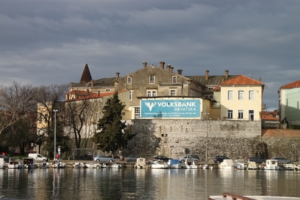 View of walls surrounding Zadar’s Old Town — and a very current advertiser’s billboard. The natural harbor between the Zadar peninsula and mainland Zadar is in the foreground. 