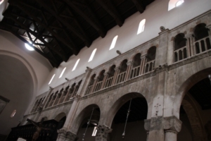 Interior of the Zadar Cathedral, where smooth-surfaced walls at the top reveal the portions that were destroyed during World War II and rebuilt after.